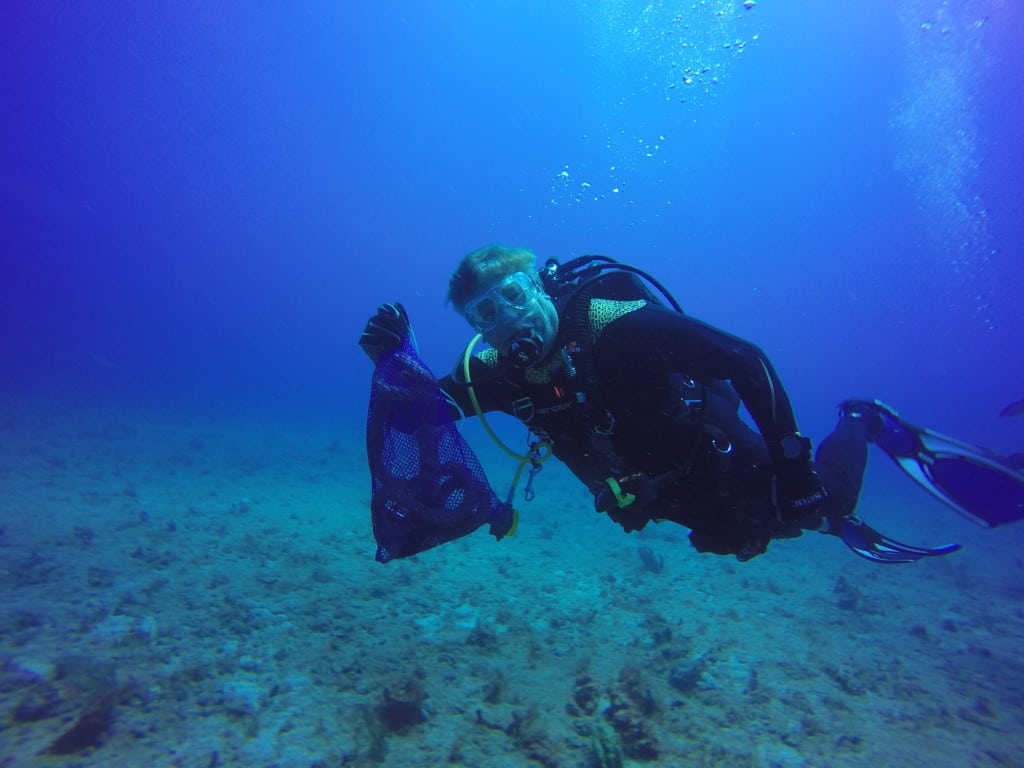 SCUBA diver removes trash and debris from Palm Beach's reef during underwater cleanup