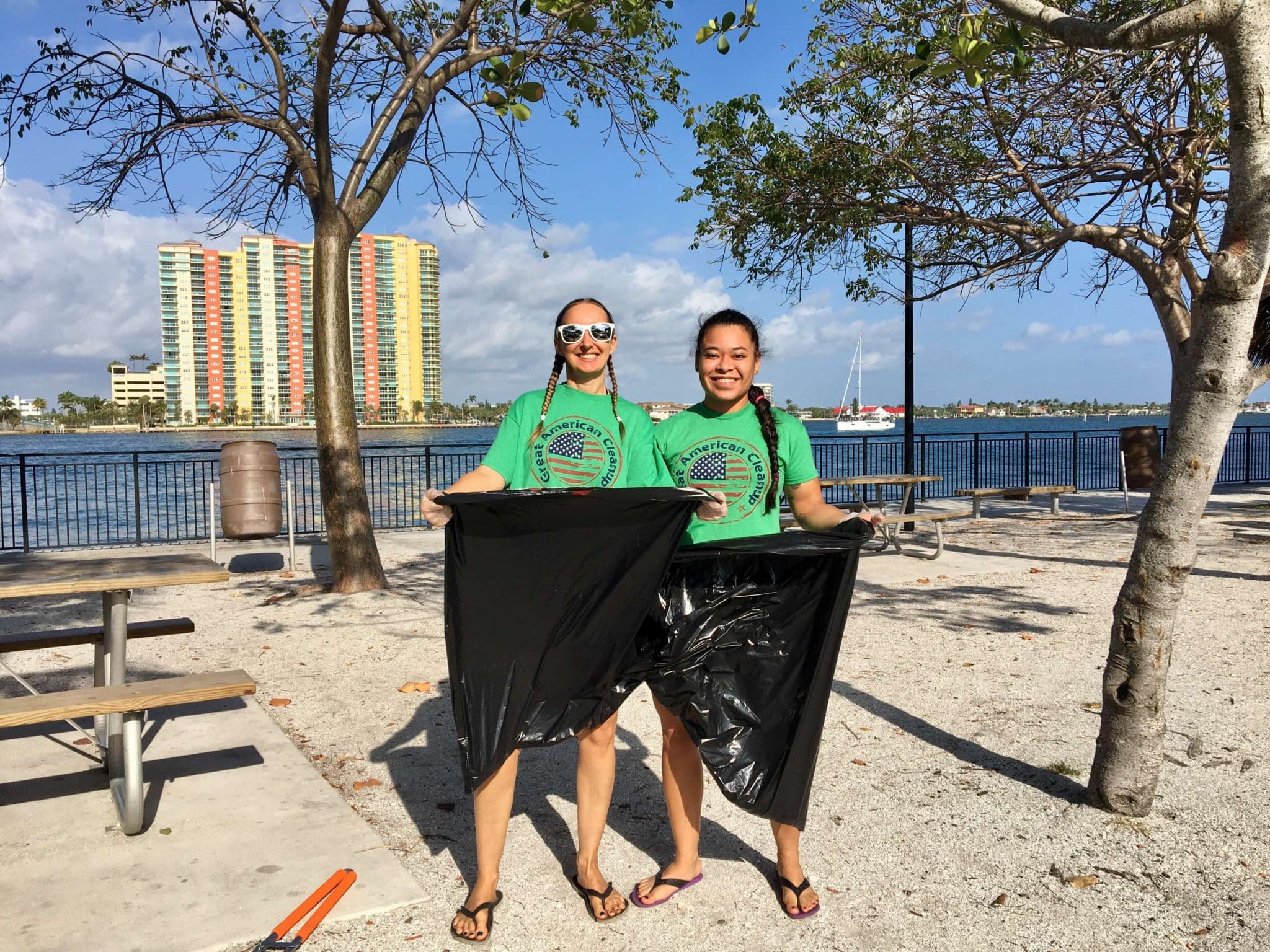 two girls collecting trash at the great american beach & reef cleanup